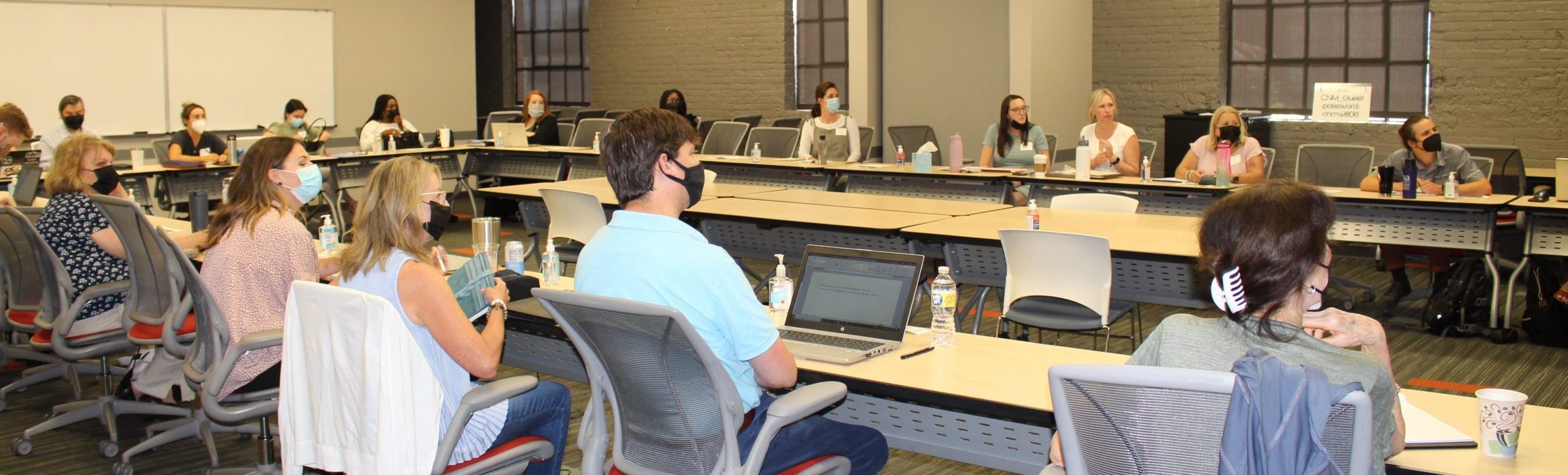 Diverse group of non profit employees looking at the presentation in the conference room setting